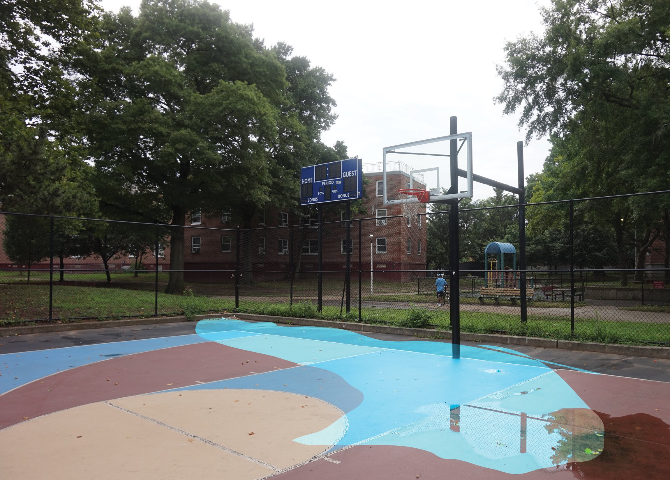 Ponding of floodwaters accumulate on basketball court, limiting use